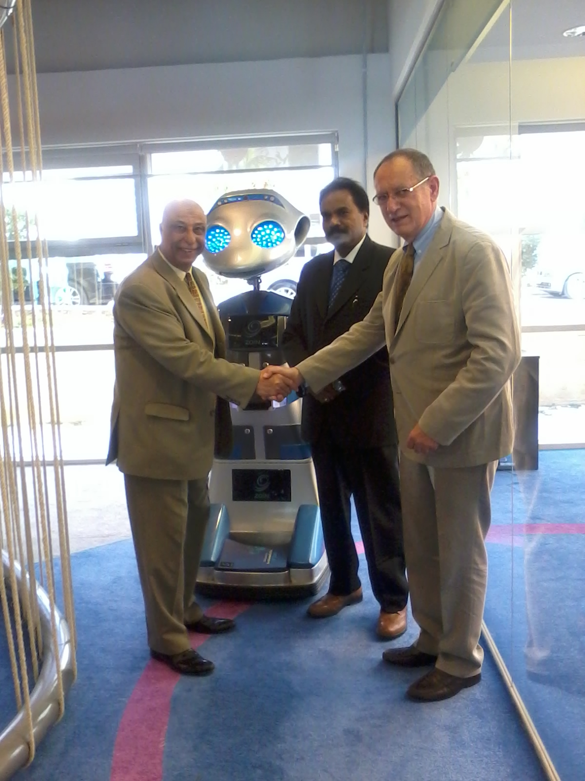 From Left to right, Engineer Khattab Omar Abuisbae, Mr. Joseph, and Mr. Philips, at "MENA ICT Forum 2014, With The  Amazing "Robotic Man", Amman City, Jordan.